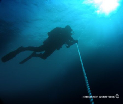 Diver decompressing on an ascent line, on one of the many... by Steve Jarocki, Jr. 